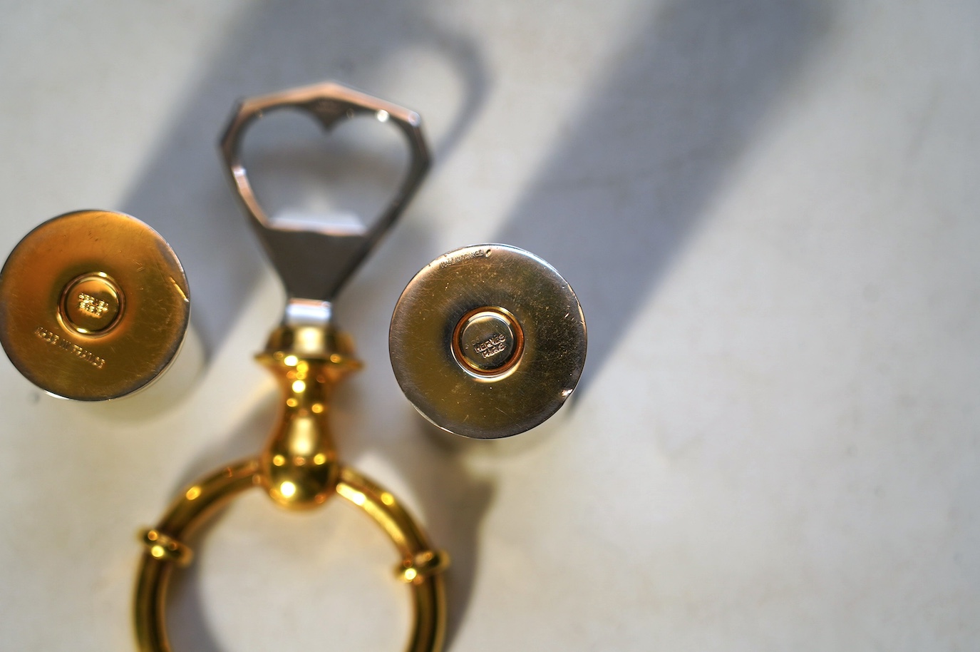 A pair of Hermes 'shotgun cartridge' handles and bottle opener